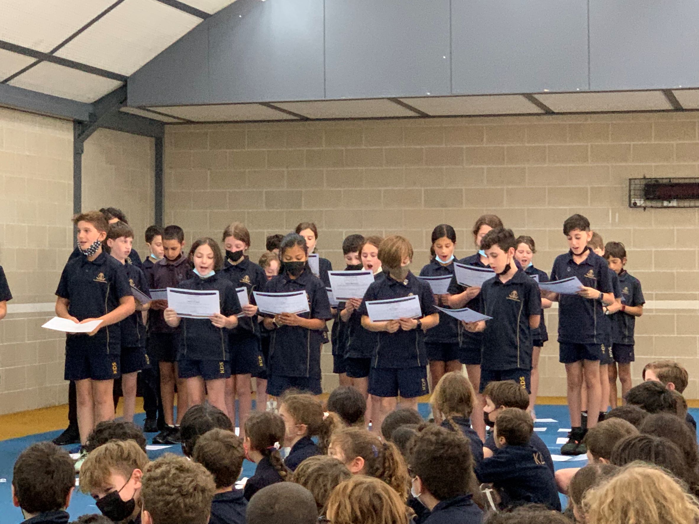 Year 5 students standing in a group with their mouths open taking their leadership oath