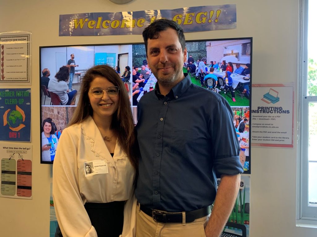 Amit and Ahlam are looking at the camera and smiling. They have just present about the importance of building co-existence