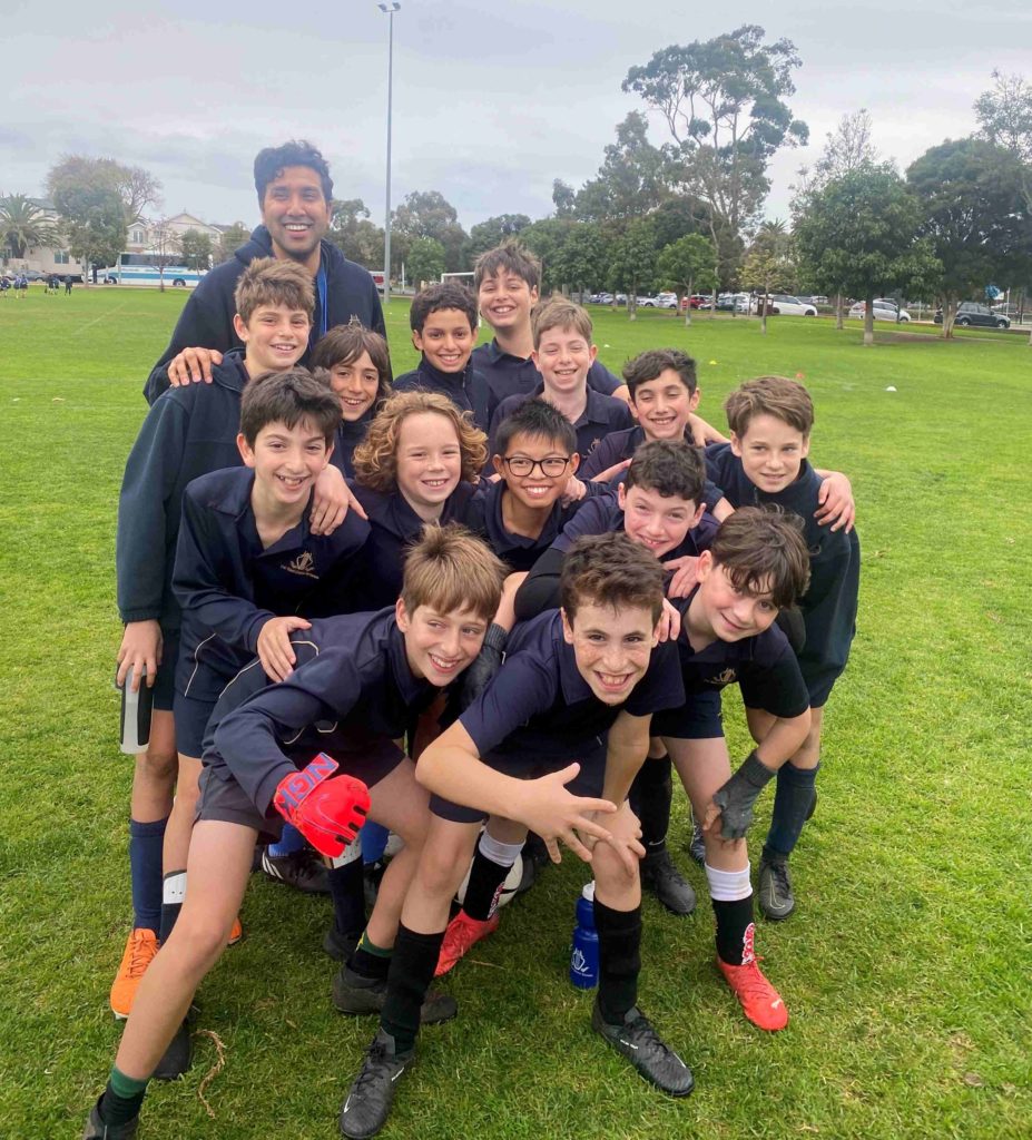 Our Year 6 boys' soccer team are huddled together, smiling. They have just won the BDSPPA round robin and are the champions for 2023