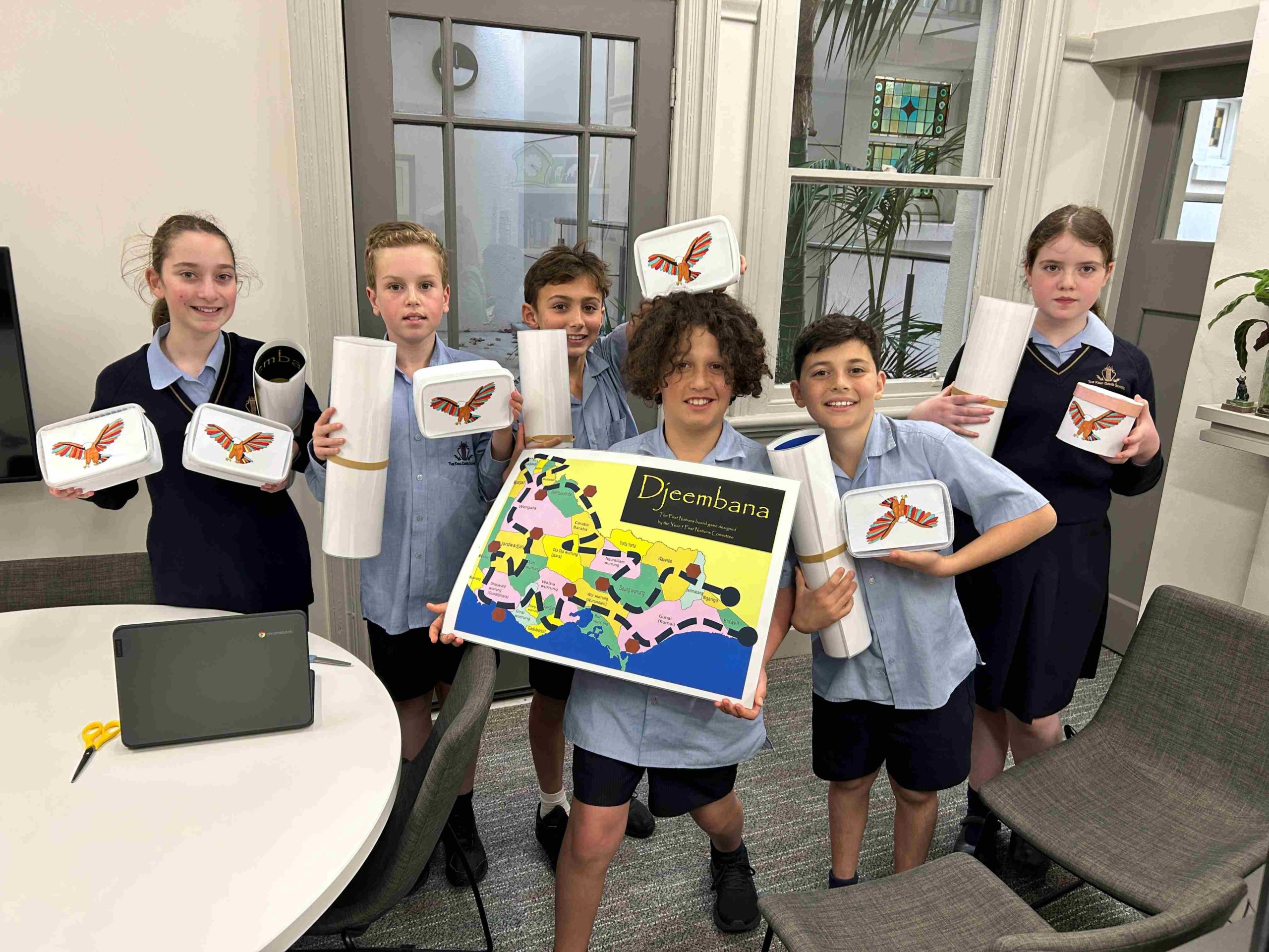 Year 5 students pose with the First Nations education game they have created.