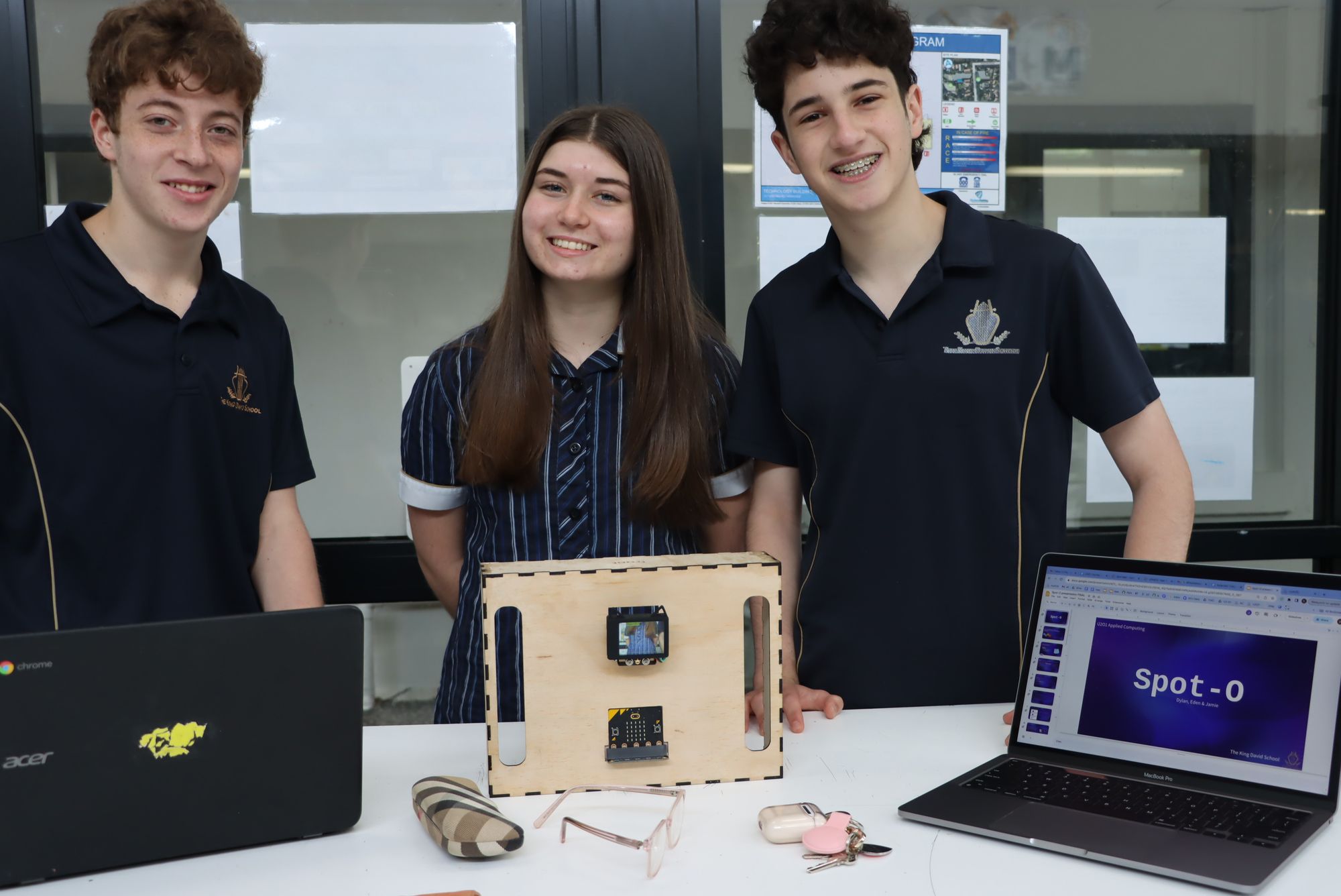 Three smiling computing students pose with their machine learning tool 'Spot O' which helps people locate lost items.