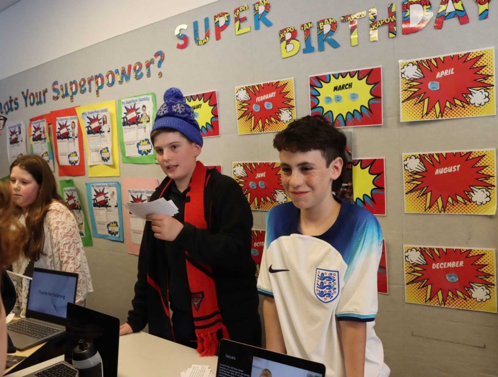 Three Year 6 students are dressed as their chosen historical leaders. They are resenting information about the leaders.