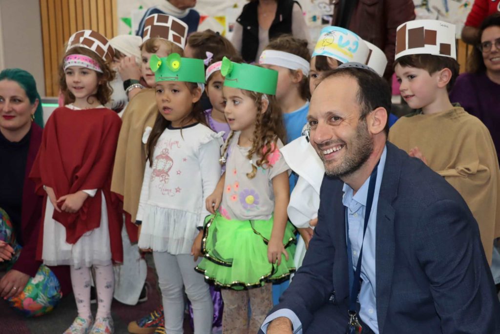Principal Marc Light joins a ELC Seder where the children are dressed as frogs, slaves and princesses - acting the story of Pesach.