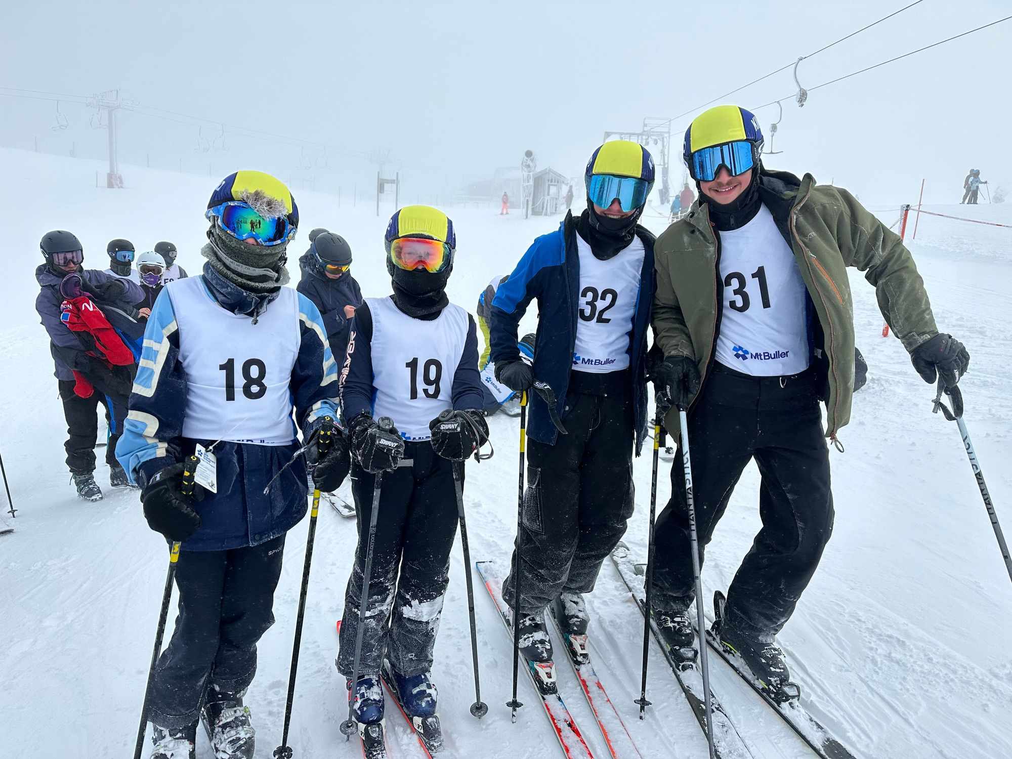 Four King David students are in ski clothes, including ski goggles and helmuts. They are on skis and holding ski poles. They are at Mt Buller in the snow about to compete in the Jewish Interschools Skiing competition.