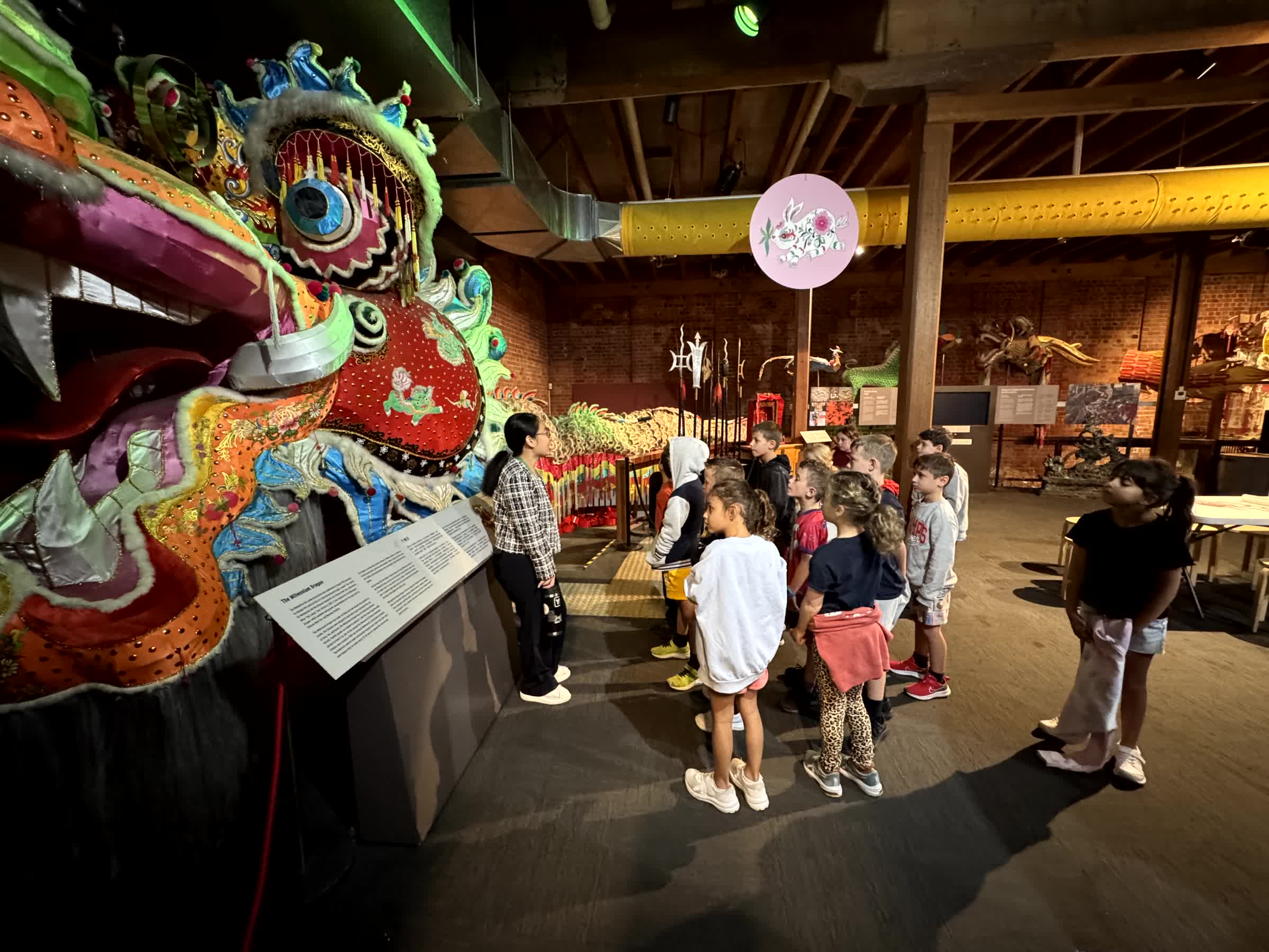 Year 2 students are at the Chinese Museum. they are learning about Lunar New Year and admiring a colourful dragon.