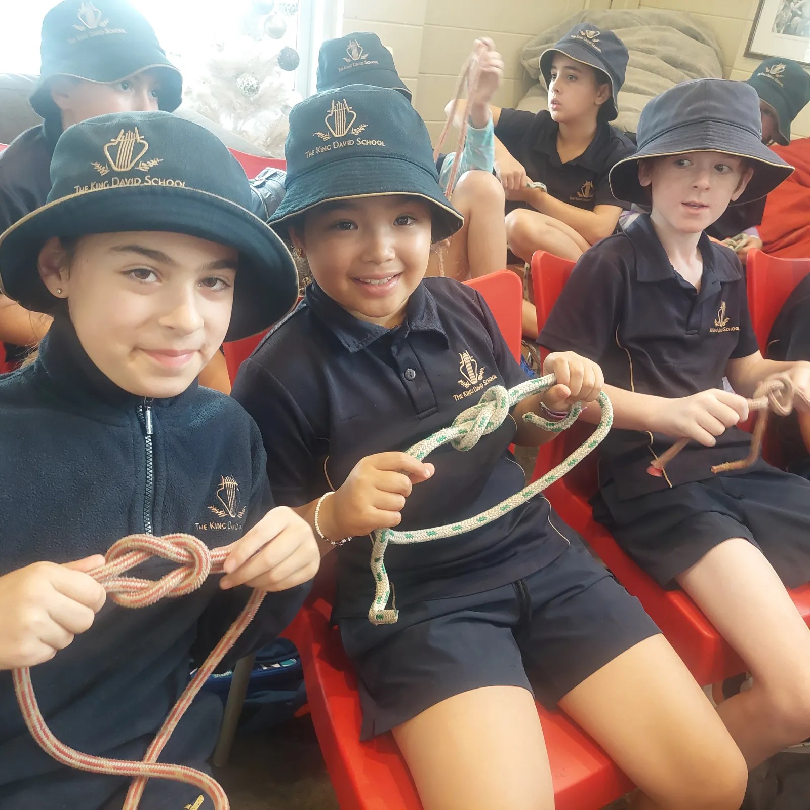 Three Year 4 students show the knots that they have been learning how to create. They are learning how to sail.