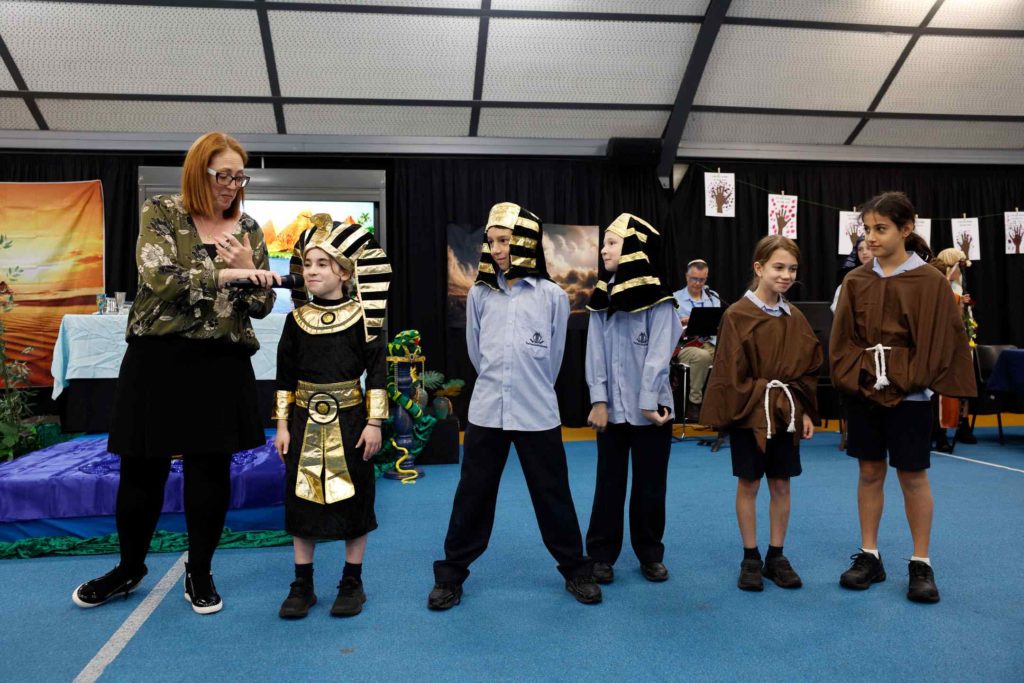 Years 3-5 students are in costume as Pharoahs and slaves. They are acting out the story of Pesach and our exodus from Egypt. They are having a Pesach seder at school.