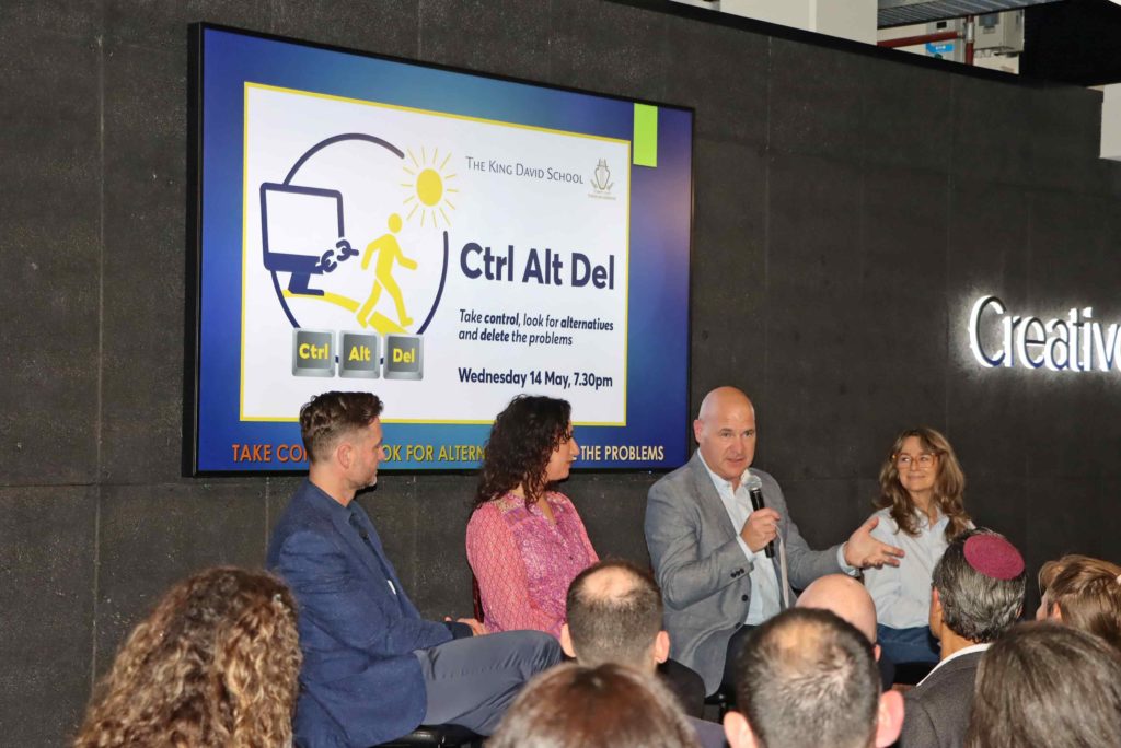 David Opat speaks at the Ctrl Alt Del launch - he's on a stage with four other panelists, including Chanie Stock, Wellbeing Coordinator.