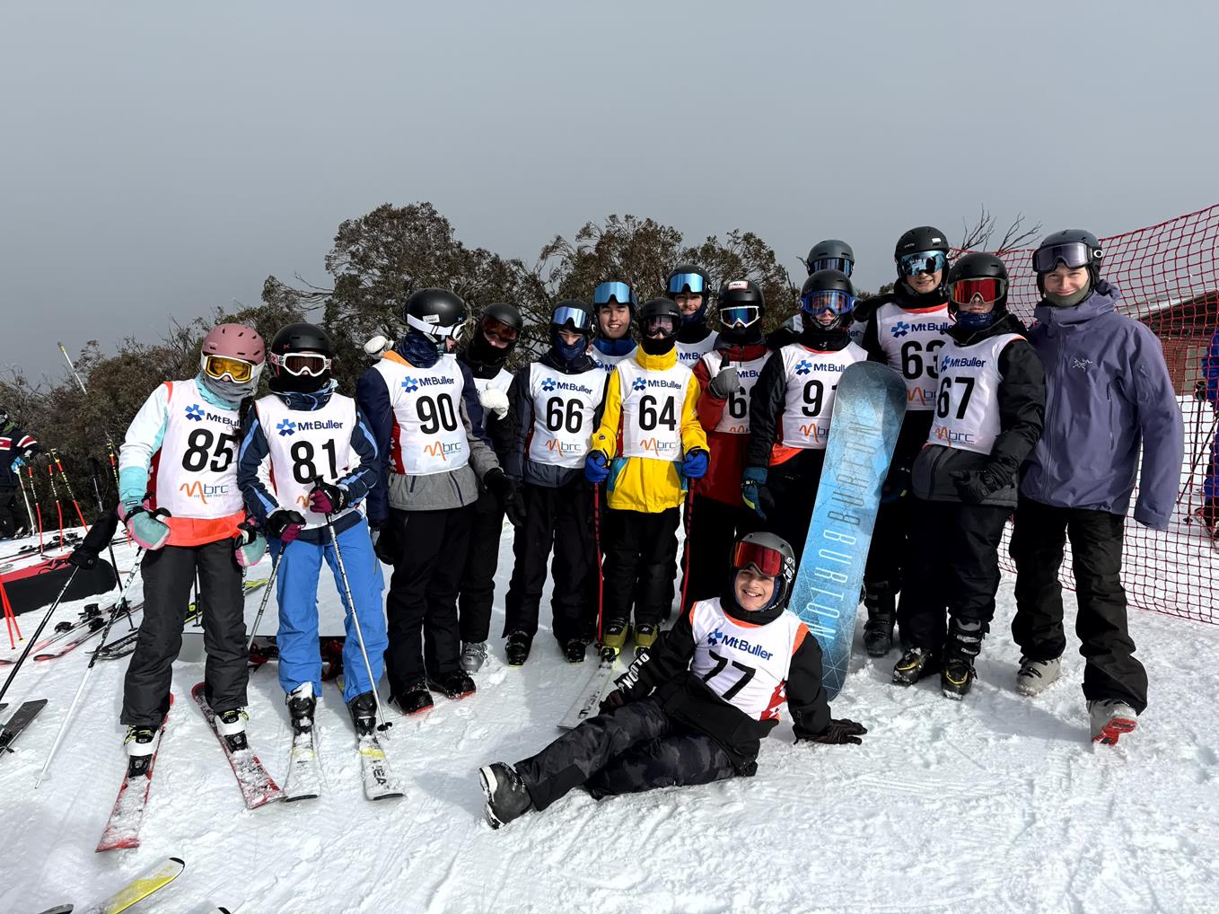King David students are together on Mt Buller. They are wearing snow clothes and bibs with competitor numbers on them. They are at the 2025 ABL Jewish Interschools Ski Competition.