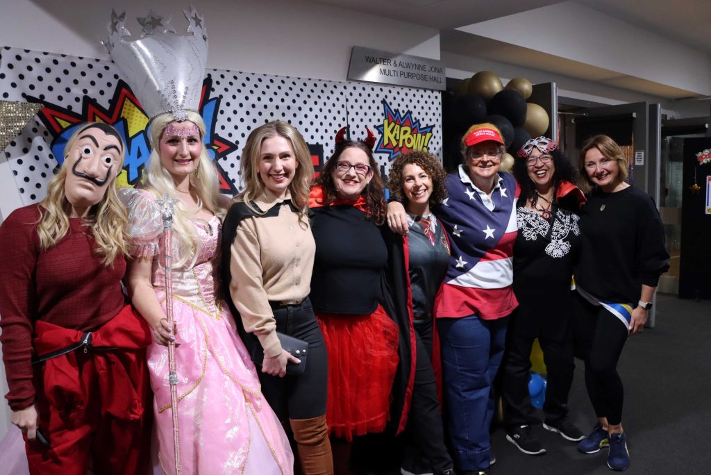 Members of the KDSPA pose together at the RMC. They are dressed in costumes for the heros and villians trivia night theme.