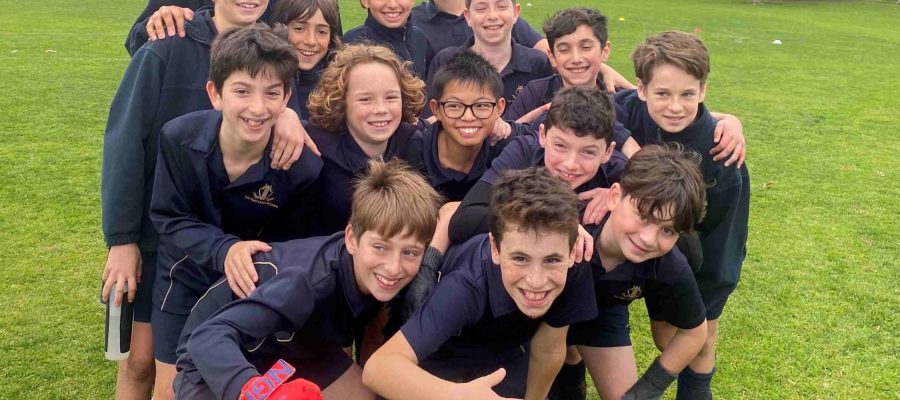 Our Year 6 boys' soccer team are huddled together, smiling. They have just won the BDSPPA round robin and are the champions for 2023