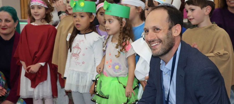 Principal Marc Light joins a ELC Seder where the children are dressed as frogs, slaves and princesses - acting the story of Pesach.