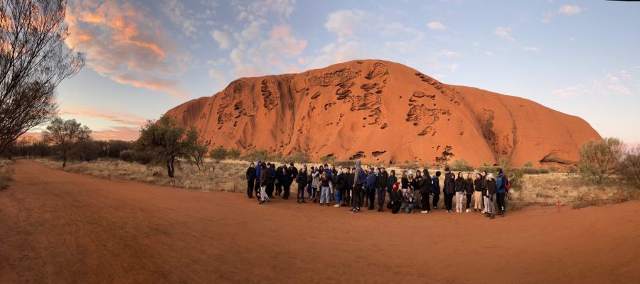 A group of Year 8 students are in front of Uluru in Central Australia
