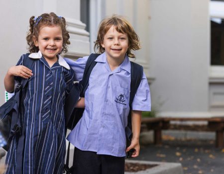 Two Prep students in King David school uniform are looking at the camera and smiling. They are happy to be at school.